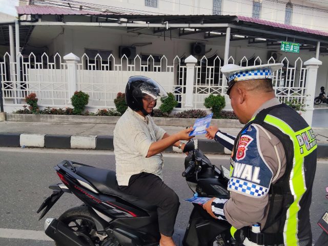 Personel Satlantas Polres Aceh Barat membagikan brosur dan menyampaikan edukasi keselamatan berlalu lintas kepada pengguna jalan di Simpang Empat Rundeng dalam Operasi Patuh Seulawah 2026. Jumat (30/10/2026) Dok. Polres Aceh Barat